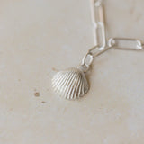 detailed view of silver cockle shell charm bracelet on paperclip chain, coastal-inspired handcrafted jewellery by Iris & Lolli