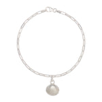 recycled silver cockle shell charm bracelet with fine paperclip chain on white background, sustainable coastal jewellery by Iris & Lolli