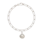recycled silver cockle shell charm bracelet with paperclip chain on white background, handcrafted coastal jewellery by Iris & Lolli