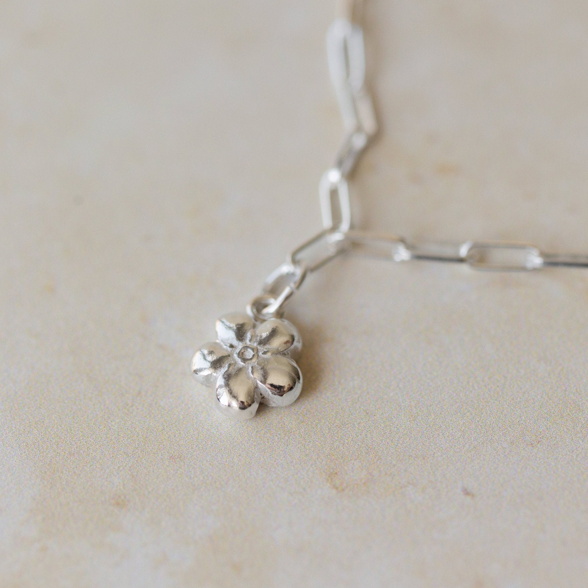 silver forget me not flower charm bracelet with delicate paperclip chain, handcrafted floral charm jewellery by Iris & Lolli
