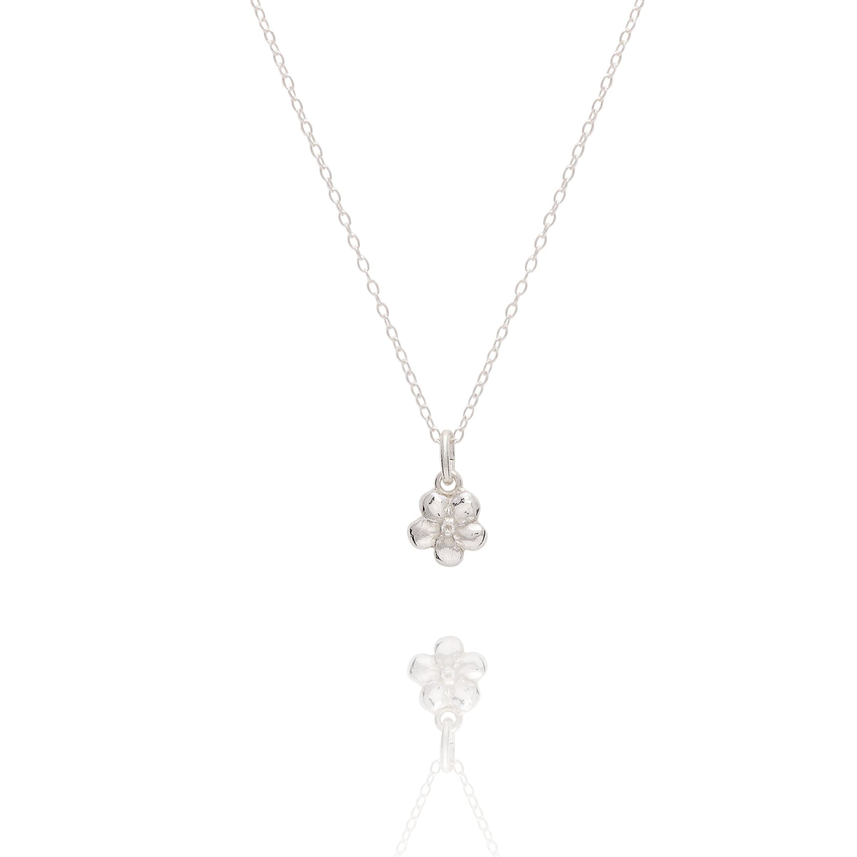 fine silver forget me not flower pendant necklace displayed on white background, delicate floral jewellery design
