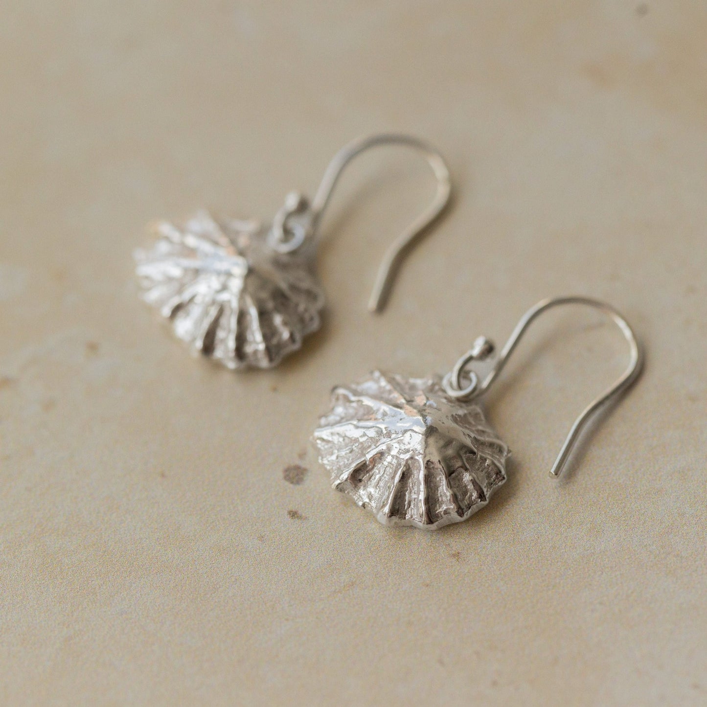 Handmade recycled silver limpet shell drop earrings inspired by the sea, crafted in the UK by Iris and Lolli