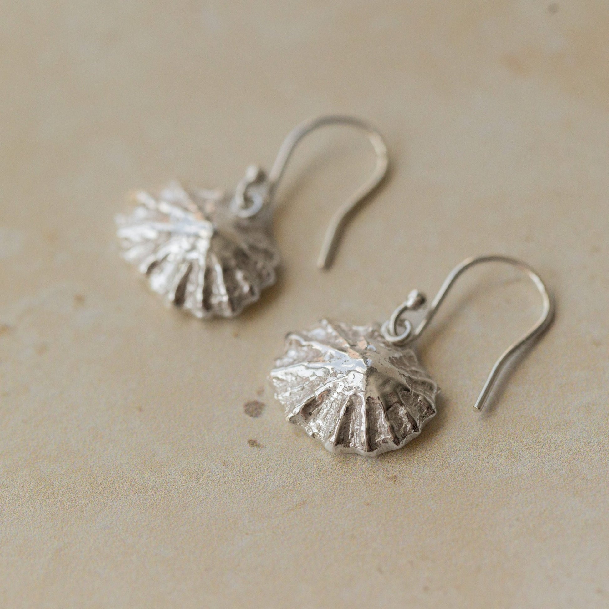 Handmade recycled silver limpet shell drop earrings inspired by the sea, crafted in the UK by Iris and Lolli
