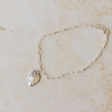 recycled silver rose leaf charm bracelet with paperclip chain on neutral background, handmade botanical jewellery by Iris & Lolli