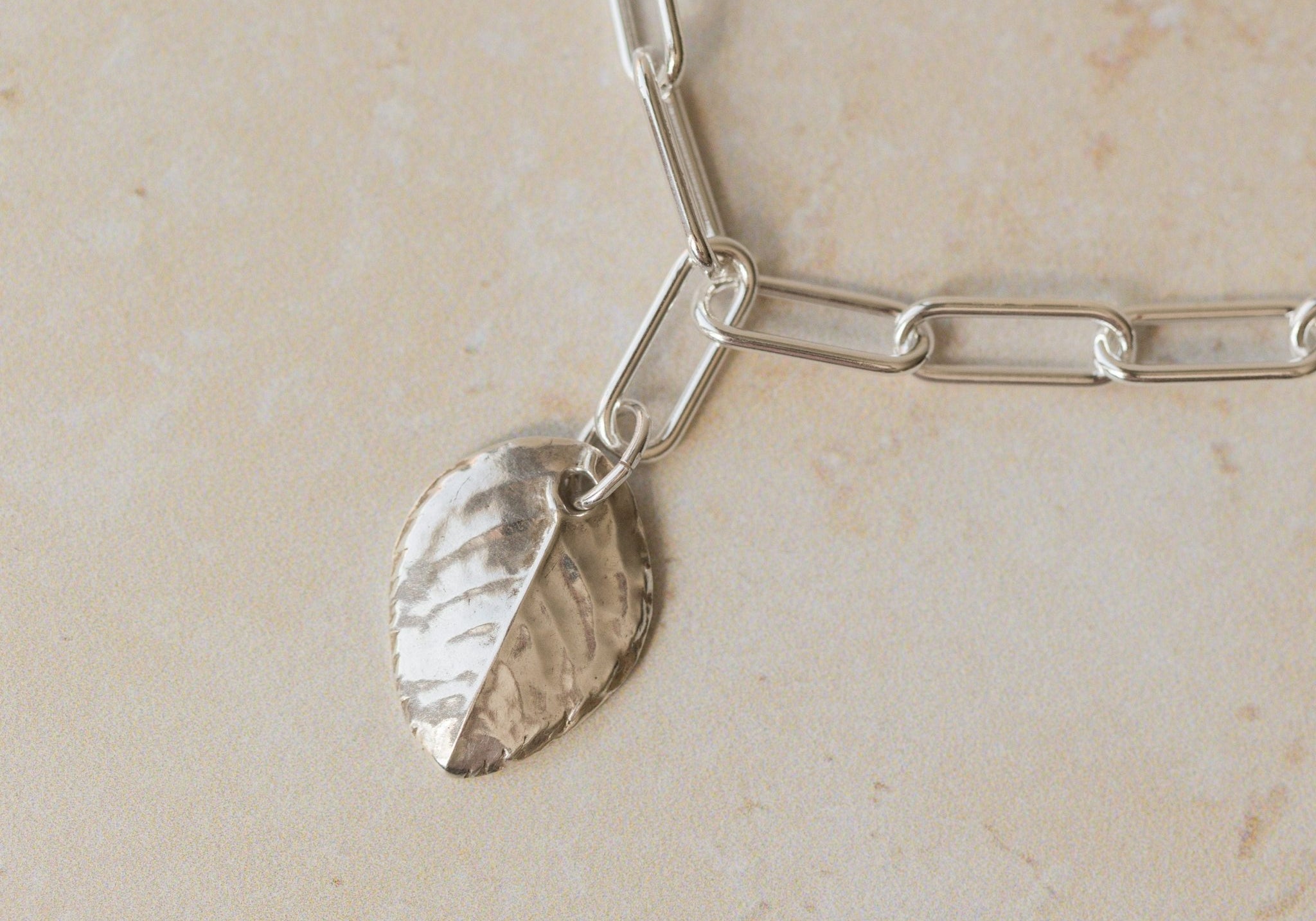 close up of recycled silver rose leaf charm bracelet with paperclip chain, handcrafted eco silver jewellery by Iris & Lolli