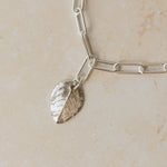 close up of recycled silver rose leaf charm bracelet with paperclip chain, handcrafted eco silver jewellery by Iris & Lolli