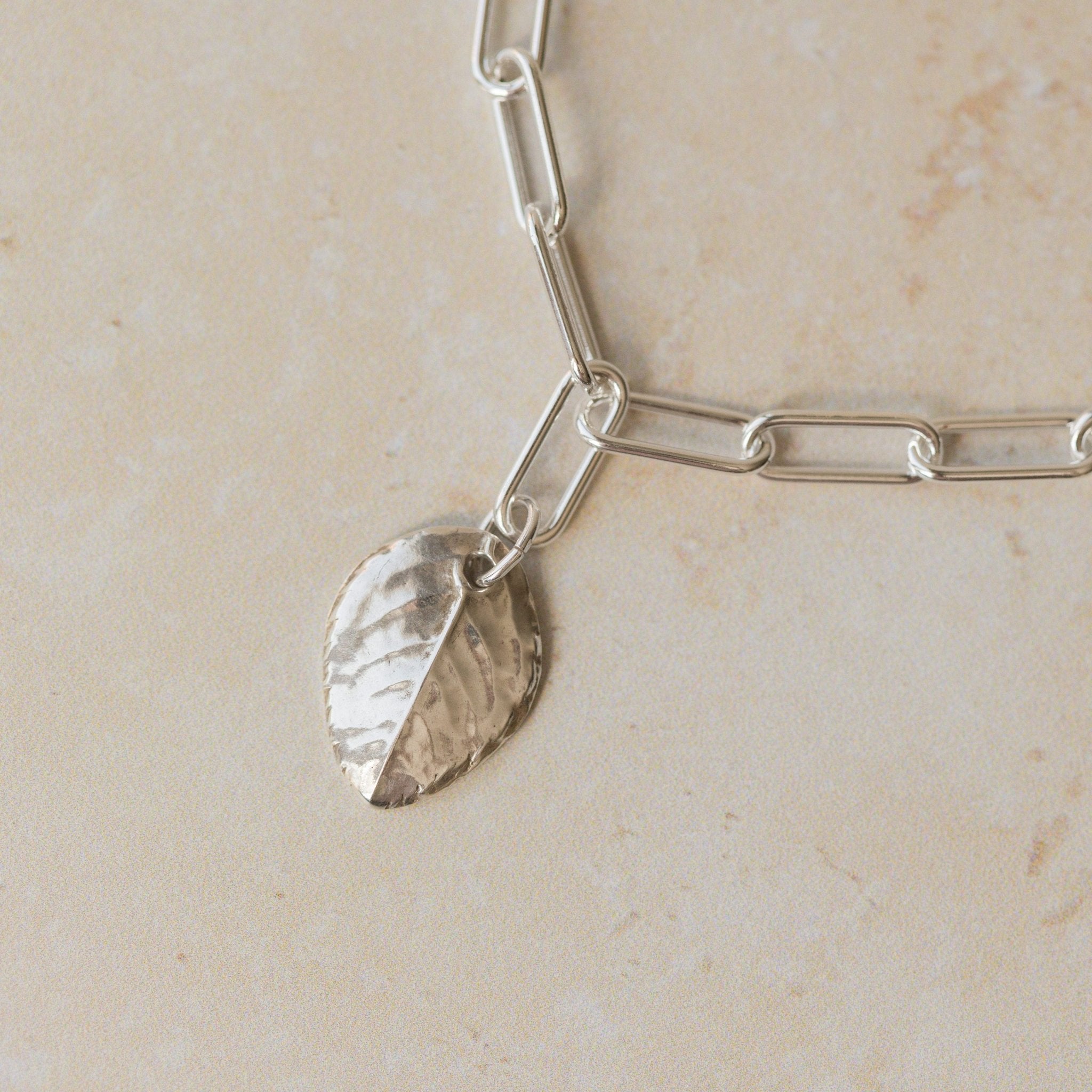 close up of recycled silver rose leaf charm bracelet with paperclip chain, handcrafted eco silver jewellery by Iris & Lolli
