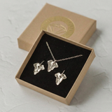 Dainty silver ivy leaf necklace and matching earrings presented together in a jewellery gift box